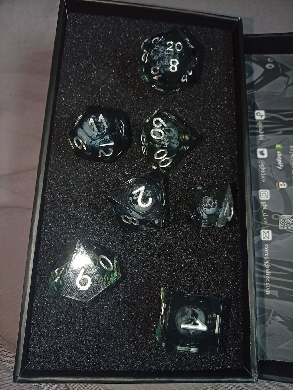 Dark Sorcerer's Skull Frame Liquid Core Resin Dice Set Silver Font