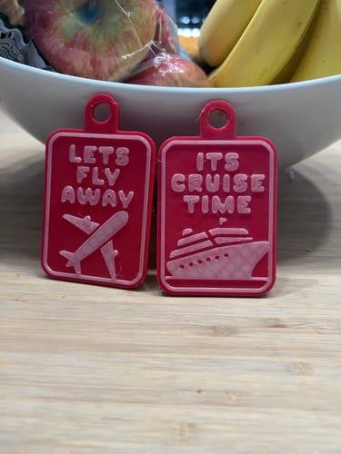 Flexible pink luggage tags reading Lets Fly Away and Its Cruise Time printed in Filaments.ca TPU