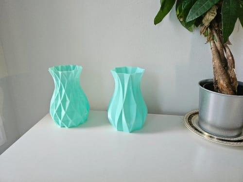 Two spiral vases printed in EconoFil Pastel Green PETG next to a houseplant