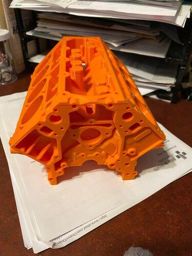 Large 3D printed V8 engine block model in EconoFil Dark Orange PLA, a 71 hour print shown fresh off the printer
