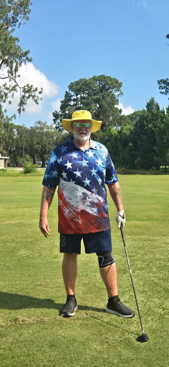 Wayne on the golf course in an Obnoxious Golf flag polo