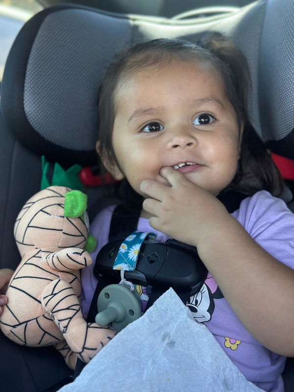 Child excited with Baby Mummy plush