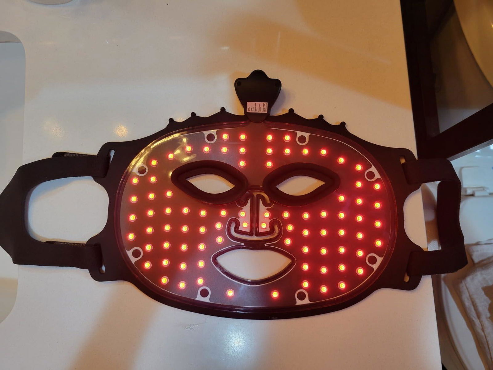 Customer wearing red light mask